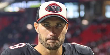 Kirk Cousins walking off the field at Mercedes-Benz Stadium after a Falcons game.