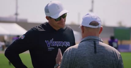 Kevin O’Connell talks with a coach during Vikings and Patriots joint practice at TCO Performance Center.