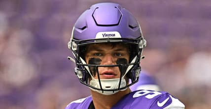 J.J. McCarthy warms up on the field at U.S. Bank Stadium before a preseason game against the Houston Texans.