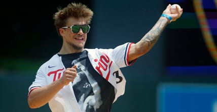 Koi Perich, a Golden Gopher, throws out a pitch a Twins game
