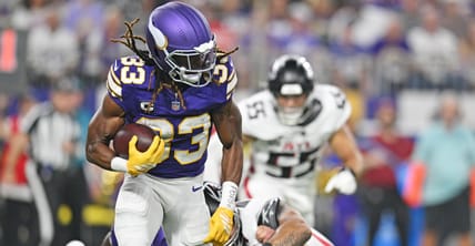 Aaron Jones Sr. runs the ball for the Vikings against the Falcons at U.S. Bank Stadium.