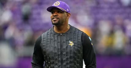 Brian Flores looks over the field before a Vikings game against the Packers at U.S. Bank Stadium.