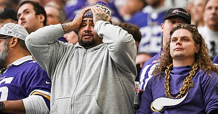 Vikings fans react during a tense fourth-quarter moment against the Ravens in Minneapolis.