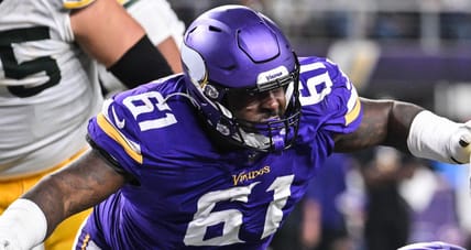 Josh Jacobs scores while Jalen Redmond chases during Vikings-Packers game in 2024.