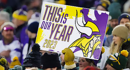 Vikings fans hold up a sign during a game at Lambeau Field.