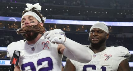 Harrison Smith eats a steak while being interviewed by Dianna Russini on the field at U.S. Bank Stadium after a Vikings game.