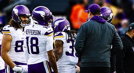 T.J. Hockenson and Justin Jefferson stand together on the Vikings sideline.