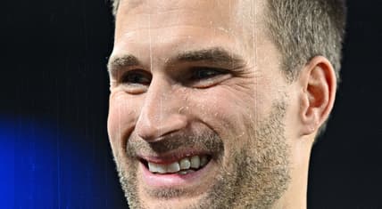 Kirk Cousins standing on the field before a Vikings game at U.S. Bank Stadium.