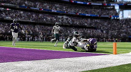Jordan Mason scores a touchdown against the Eagles at U.S. Bank Stadium.