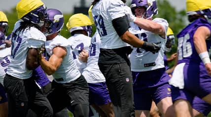 Jake Golday practices with Vikings defenders during OTAs in Eagan.