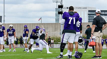 Christian Darrisaw stands near the sideline during Vikings training camp.