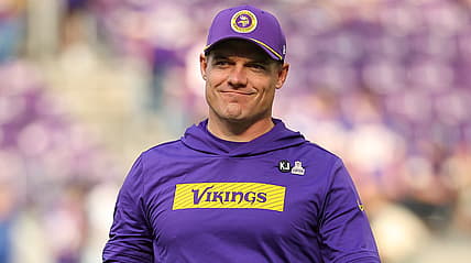 Kevin O’Connell standing on the sideline before a Vikings game at U.S. Bank Stadium.