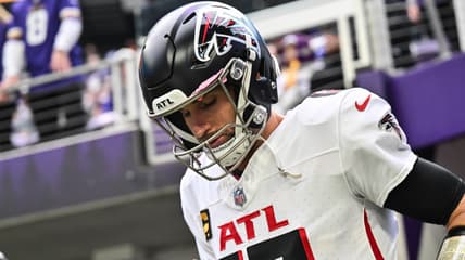 Kirk Cousins enters the field before a game against the Vikings at U.S. Bank Stadium.