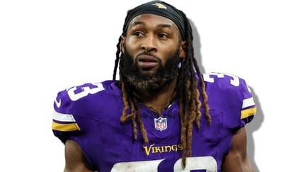 Aaron Jones looks on from the sideline during a Vikings home game