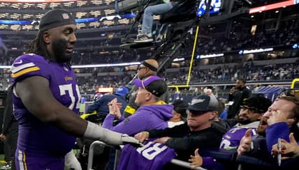 Bo Richter and Donovan Jackson celebrate with Minnesota Vikings fans after a game against the Dallas Cowboys.