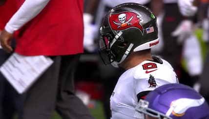 Baker Mayfield in Tampa Bay uniform beside the Vikings sideline.