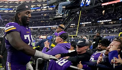 Bo Richter and Donovan Jackson celebrate with Minnesota Vikings fans after a game against the Dallas Cowboys.