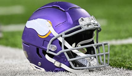 A Minnesota Vikings helmet sits on the turf before a game against the Chicago Bears.