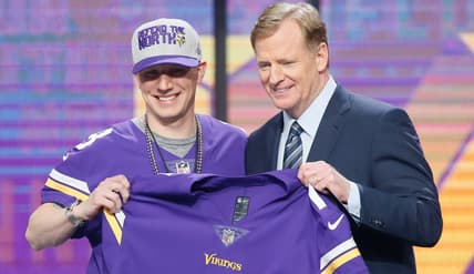 A fan poses with NFL commissioner Roger Goodell after being drafted by the Vikings in 2018.