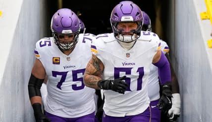 Blake Cashman and Brian O'Neill take the field before a Vikings game against the Packers at Lambeau Field.