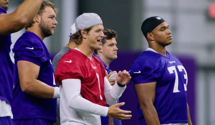 J.J. McCarthy chats with Ryan Van Demark and Walter Rouse during Day 3 of Vikings minicamp in Eagan, Minnesota.