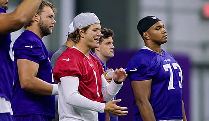 J.J. McCarthy chats with Ryan Van Demark and Walter Rouse during Day 3 of Vikings minicamp in Eagan, Minnesota.