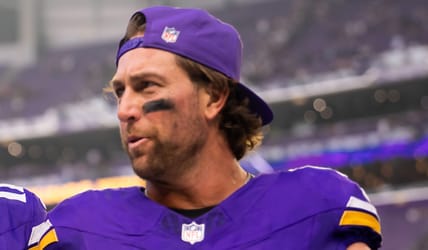 Max Brosmer and Adam Thielen leave the field after facing Cincinnati.