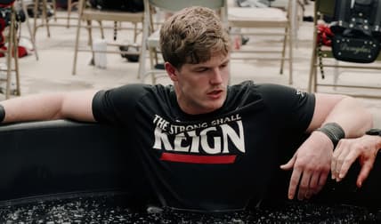 Jake Golday sits in a cold tub during a Cincinnati football training and recovery session.