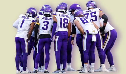 Vikings huddle on the field during a road game against the Seahawks