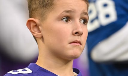 A young Vikings fans looks on during a 2022 regular season game.