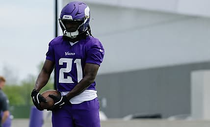Demond Claiborne holds a football during Vikings OTAs in Eagan.