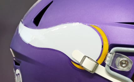 Vikings quarterback J.J. McCarthy (helmet) takes the field before a home game at U.S. Bank Stadium.