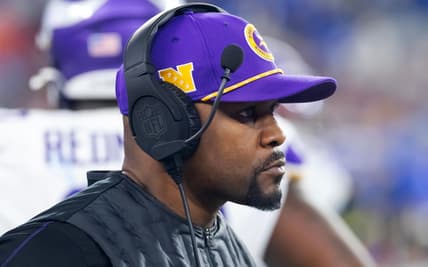 Brian Flores watches from sideline during Vikings playoff game vs. Rams.