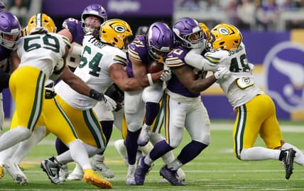 Jordan Mason runs with the football during the Vikings game against the Green Bay Packers at U.S. Bank Stadium.