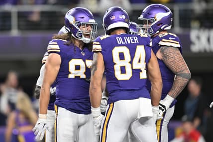 T.J. Hockenson celebrates a touchdown with Josh Oliver and Dalton Risner during a Vikings game against the Bears at U.S. Bank Stadium.