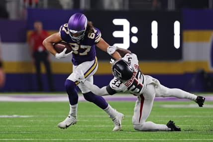 T.J. Hockenson runs after a catch against Falcons safety Billy Bowman Jr.