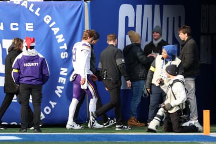 J.J. McCarthy leaves the field after an injury during a game against the New York Giants.