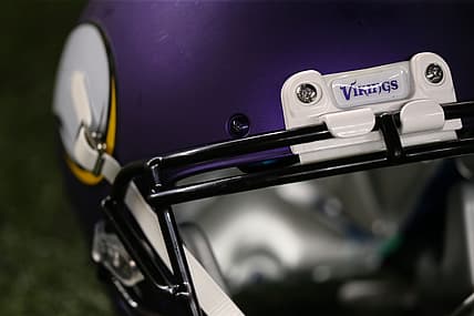 A Minnesota Vikings helmet sits on the turf before a game against the Packers at Lambeau Field.