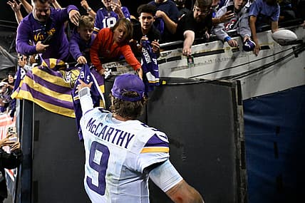 J.J. McCarthy celebrates after a Vikings road win over the Bears at Soldier Field.