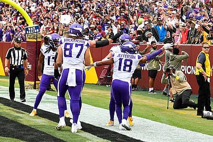 ALT: Justin Jefferson celebrates after scoring a touchdown against the Washington Commanders at FedExField.