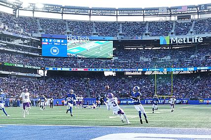 Vikings wide receiver Jordan Addison attempts to catch a pass against Giants cornerback Cordale Flott.