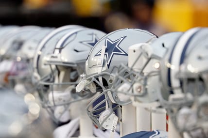 Dallas Cowboys helmets lined up on the bench at FedExField.