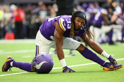 Aaron Jones of the Minnesota Vikings stretches on the field before a home game against the Lions.