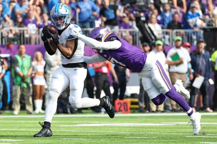 Amon-Ra St. Brown catches a touchdown pass against the Vikings during the second quarter at U.S. Bank Stadium.