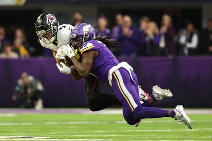 Drake London catches a pass while defended by Shaquill Griffin at U.S. Bank Stadium.