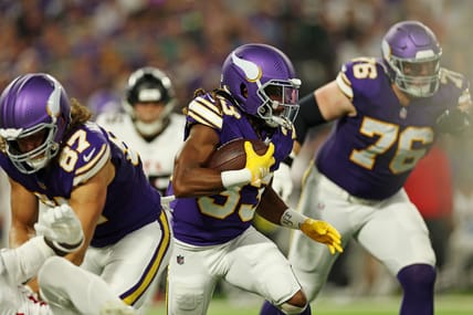 Aaron Jones Sr. carries the ball against the Falcons at U.S. Bank Stadium.