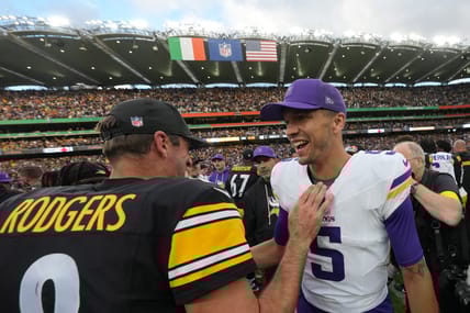Aaron Rodgers and Desmond Ridder talk on the field after the Dublin game.