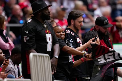 Falcons fans in 2022 at Mercedes-Benz Stadium, one wearing a Kyle Pitts jersey