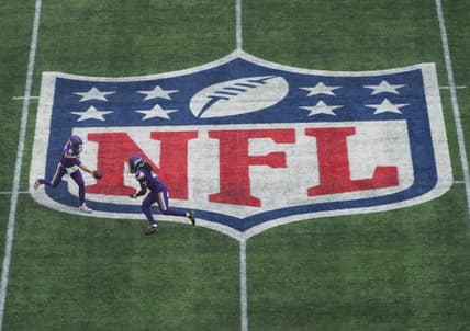 Kirk Cousins hands off to Dalvin Cook on the midfield NFL shield during the Vikings’ International Series game in London.