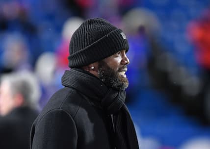 Randy Moss stands on the sideline before a Bills vs. Patriots game at Highmark Stadium.